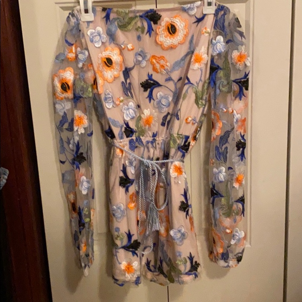 Embroidered L’Atiste romper with tie tassel accent